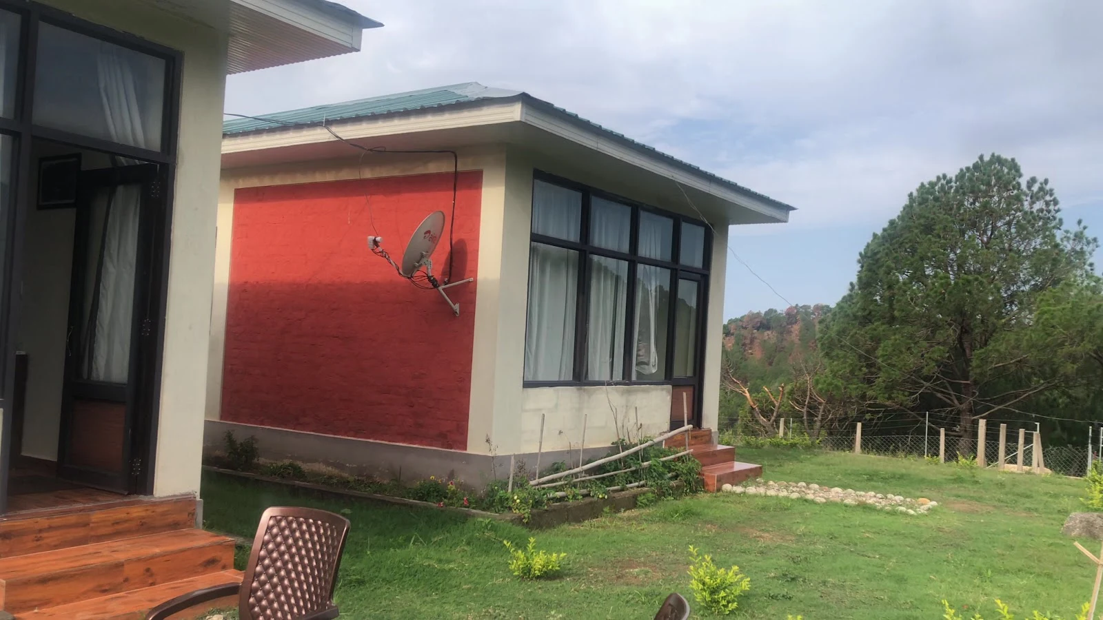 Exterior view of a red building with a garden.